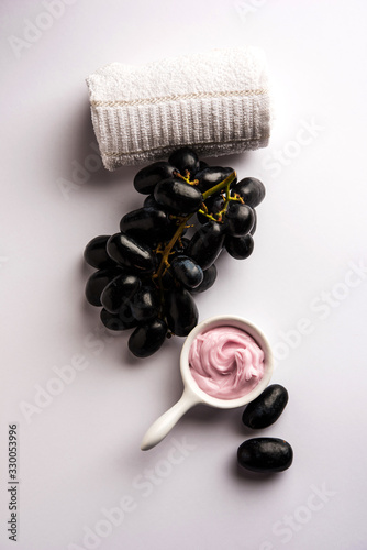 Black grapes, yogurt and honey mix face mask or cream for skin dark spot removal treatment, created using Angoor extract, curd and honey. selective focus photo