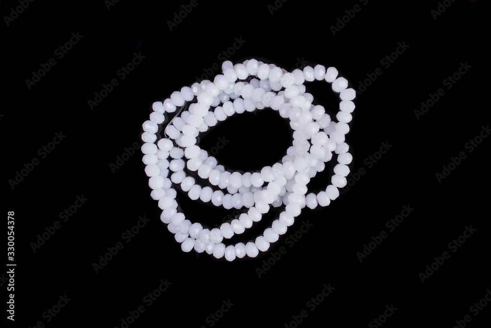 Natural stone beads on a black background isolated Natural stone beads on a black background isolated