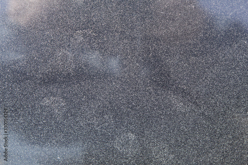 Dusty dirty glass of a car in zoom.