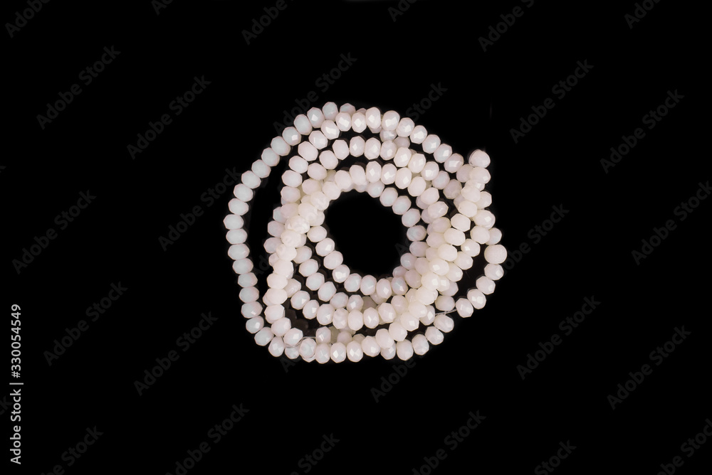 Natural stone beads on a black background isolated