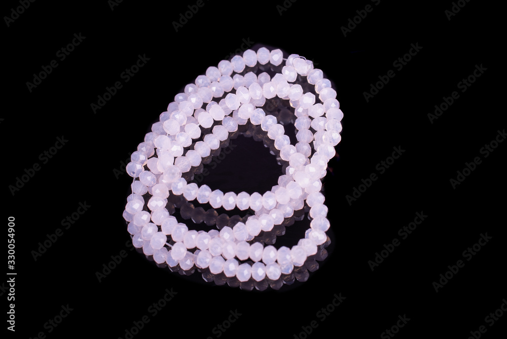 Natural stone beads on a black background isolated