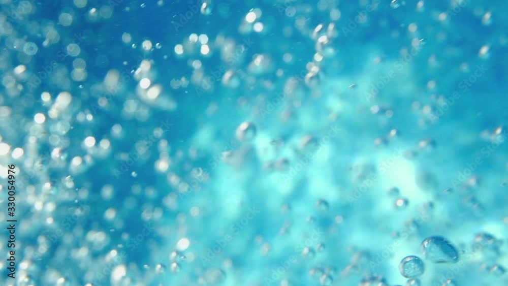 Bubbles rising to the surface. Air bubbles in water in swimming pool (underwater shot), good for backgrounds. Slow motion.