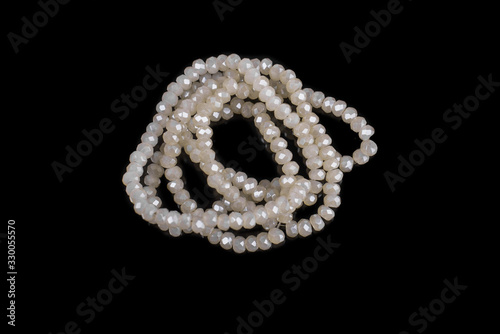 Natural stone beads on a black background isolated