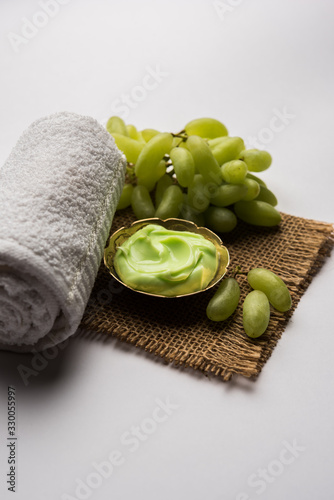 Green grapes, yogurt and honey mix face mask or cream for skin dark spot removal treatment, created using Angoor extract, curd and honey. selective focus photo