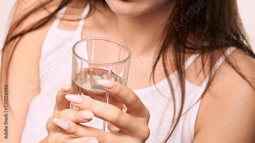 Girl drink pure water at glass. Clean mineral thirsy. Breakfast diet. Close up horizontal banner. Young woman hold mineral