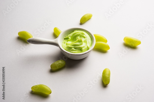 Green grapes, yogurt and honey mix face mask or cream for skin dark spot removal treatment, created using Angoor extract, curd and honey. selective focus photo