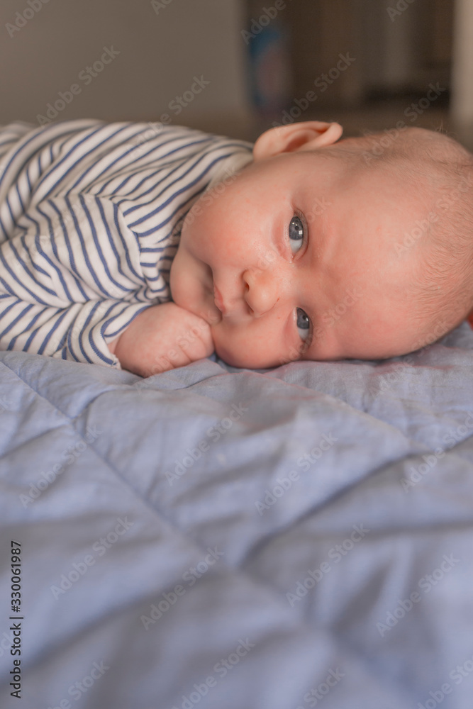 Baby boy lying on front in living room Baby boy lying on front in living room