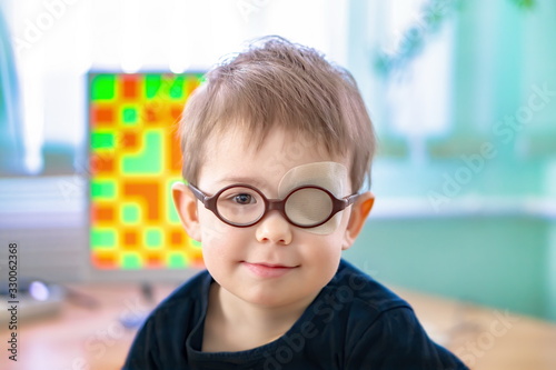 A little boy with an occluder undergoes a hardware vision treatment Fototapeta