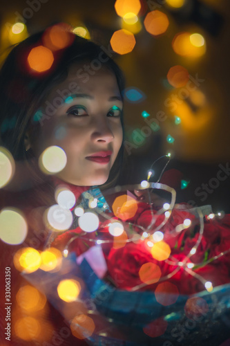Girl with a bouquet of roses and bokeh lights On valentines day © nukul2533