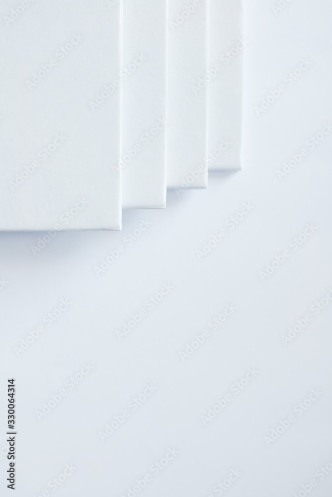 Stack of white books in geometric placement on white background. White abstract background. Copy space. Stack of white books in geometric placement on white background. White abstract background. Copy space.