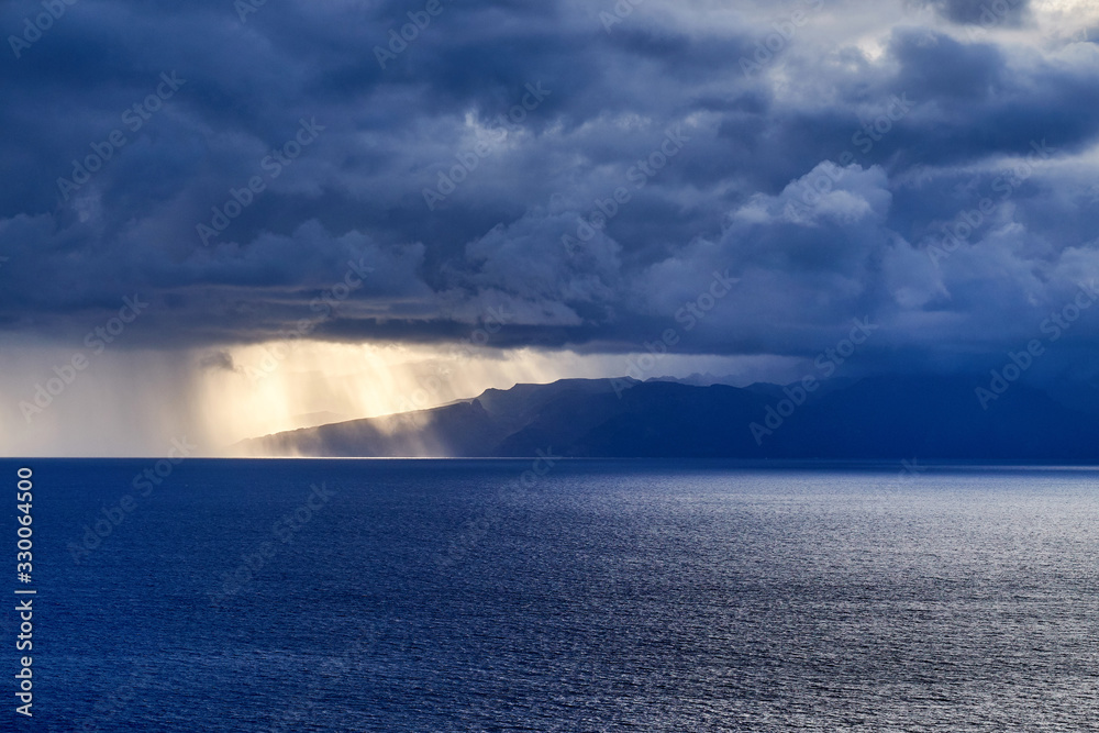 La Gomera island behind the clouds in Tenerife, Spain. La Gomera island behind the clouds in Tenerife, Spain.