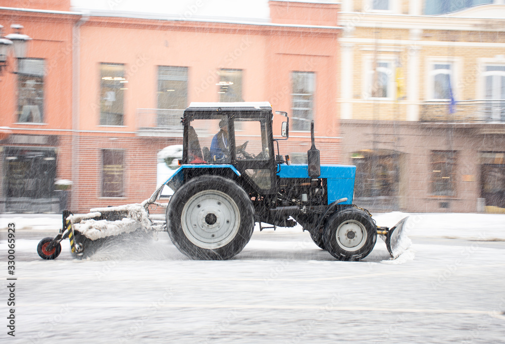 Snow removal machine cleaning the street from snow Snow removal machine cleaning the street from snow