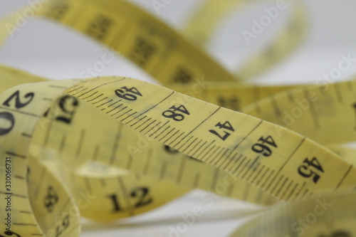 Close up shot of measurement tape isolated on white background