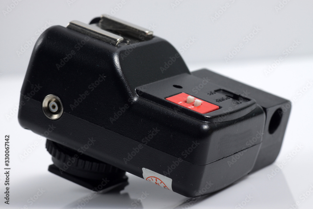 Close up shot of black camera flash trigger isolated on white background Close up shot of black camera flash trigger isolated on white background