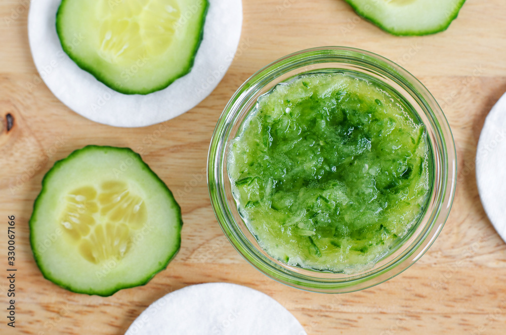 Cucumber puree, cucumber slices and cotton pads. Ingredients for preparing homemade facial mask or skin toner. Natural beauty treatment recipe, skip care and zero waste concept. Top view, copy space Cucumber puree, cucumber slices and cotton pads. Ingredients for preparing homemade facial mask or skin toner. Natural beauty treatment recipe, skip care and zero waste concept. Top view, copy space