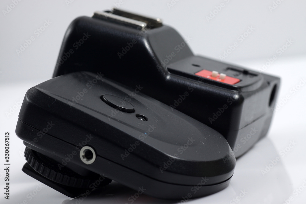 Close up shot of black camera flash trigger isolated on white background Close up shot of black camera flash trigger isolated on white background