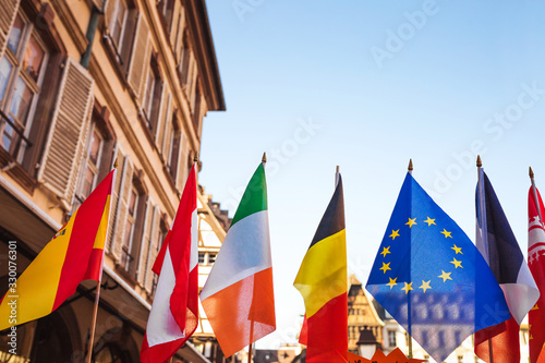 EU quarantine due to coronavirus epidemic - Set of European flags hanging on building with EU and UN flags in Strasbourg, Flance photo