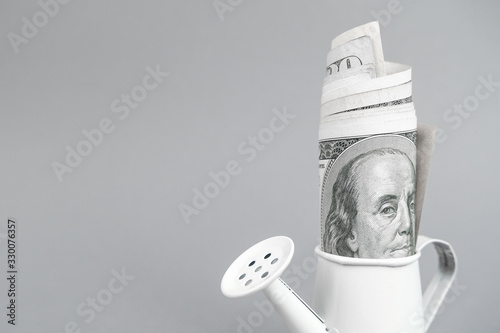 Money in the white watering. Growing, increasing money income, concept of investment, taxes, finance.