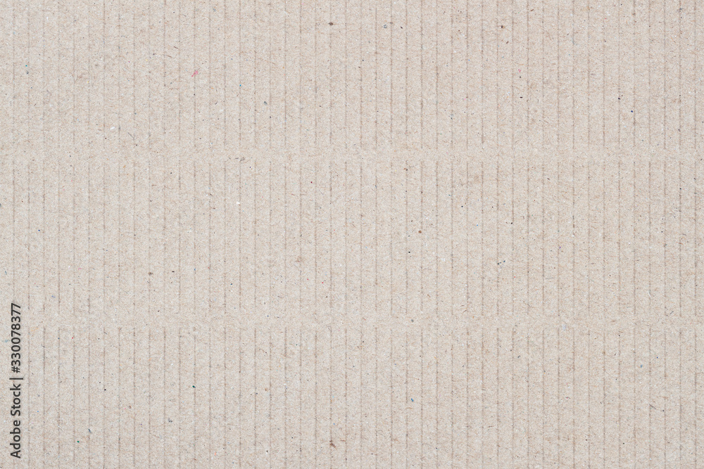 Fototapeta premium Texture of the cardboard in vertical stripes with various villi, fluff and other inclusions. Natural rough textured paper background