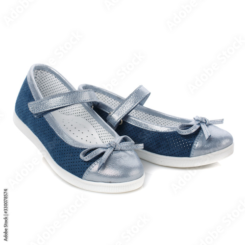 Children's blue shoes for girls with silver inserts and a silver bow isolated on white