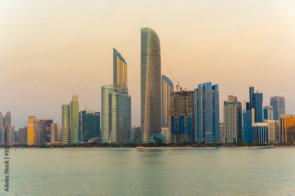 Evening view of Abu Dhabi financial district skyline. Luxury lifestyle hotels and business of United Arab Emirates. 