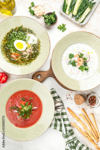 On the photo there are three dishes of borsch, okroshka, soup with egg