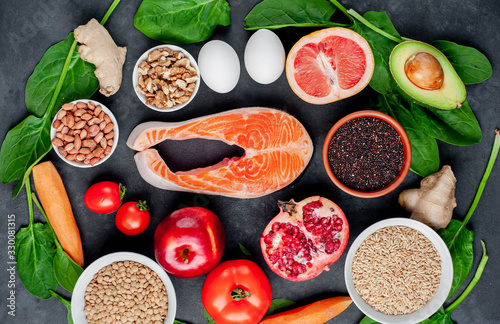 Fototapeta Naklejka Na Ścianę i Meble -  Selection of healthy food: salmon, fruits, seeds, cereals, superfoods, vegetables, leafy vegetables on a stone background. Healthy food for people.