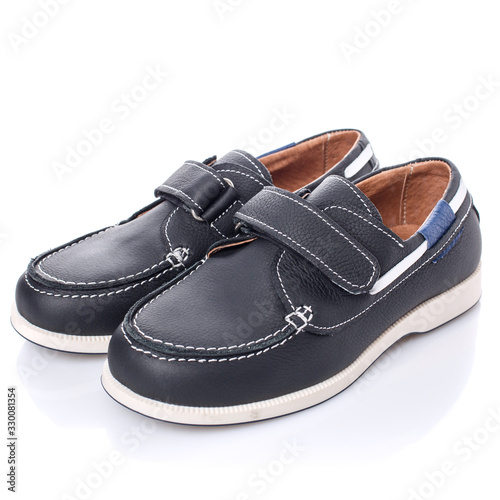 Children's black leather shoes for boys isolated on white. Side view