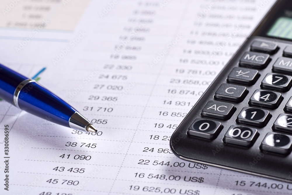 Office paper with table of numbers. Price analysis with dollar symbol, calculator and pen. Office paper with table of numbers. Price analysis with dollar symbol, calculator and pen.