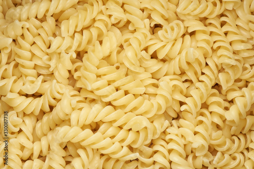 Macaroni background. Fusilli pasta top view. photo
