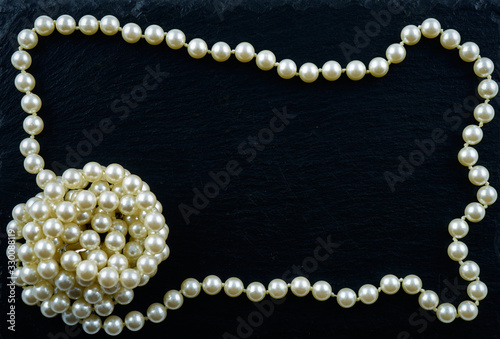 Wallpaper Mural Pearl necklace on a black slate plate, arranged in a circle, with lots of copyspace in the middle Torontodigital.ca