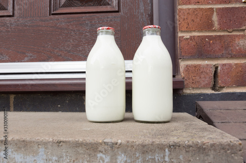 Fresh milk in recyclable glass bottles delivered to the door by a traditional milk man