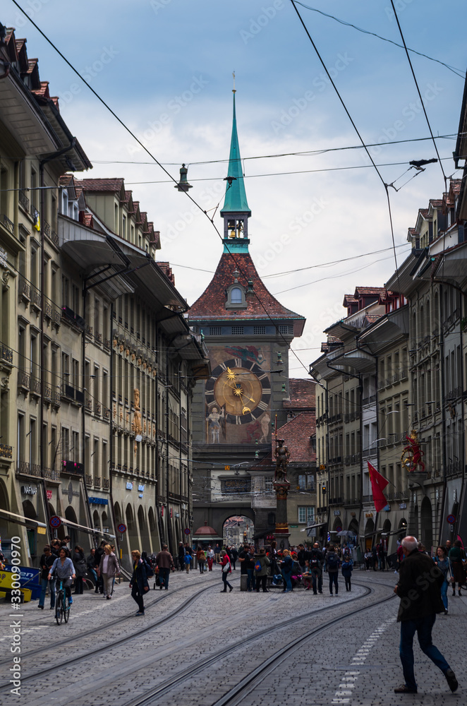 Obraz premium Bern city tower clock street view overcast day tourist walking