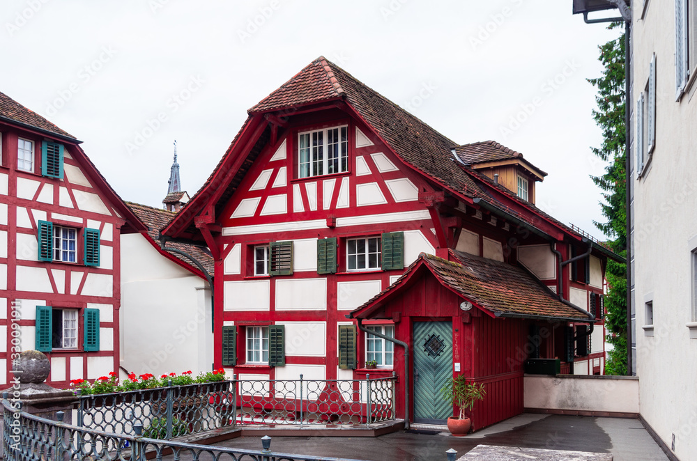 Colorful old wooden building in Lucerne Switzerland with exposed red wood overcast day Colorful old wooden building in Lucerne Switzerland with exposed red wood overcast day