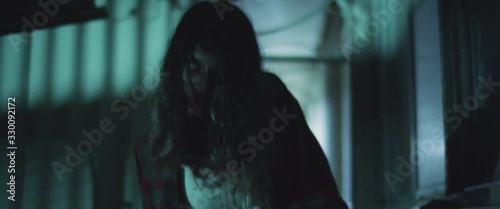 Zombie woman walking outside the building at night.Transformation zombie concept