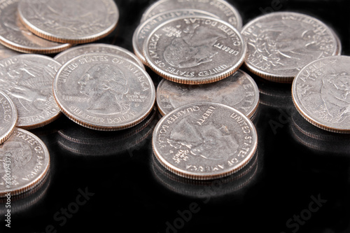 Close up of United States coins, Quarters on black background