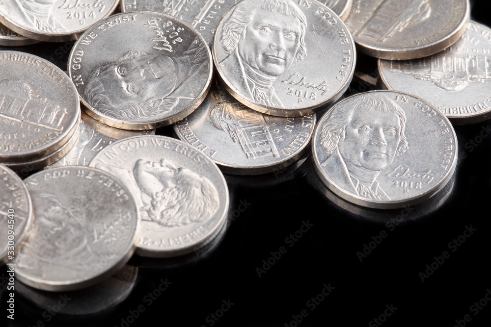 Close up of United States coins, Nickles on black background Close up of United States coins, Nickles on black background