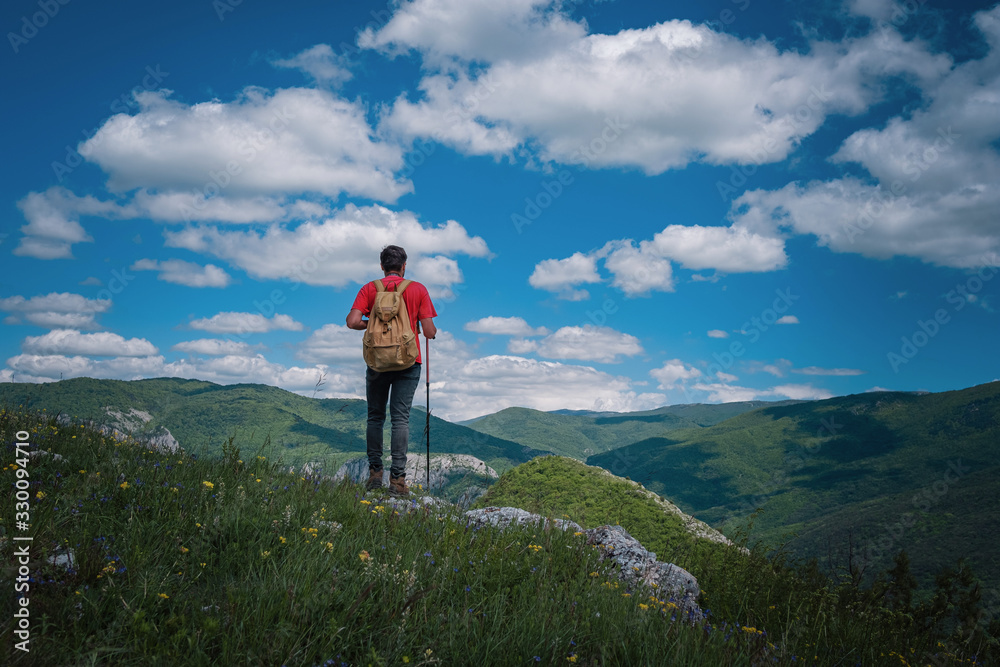 Obraz premium Traveler Man relaxing meditation with serene view mountains. Travel Lifestyle hiking concept summer vacations outdoor