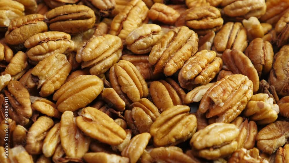 Pecan nuts background. Closeup pekan seeds. Rotate Pecan nuts background. Closeup pekan seeds. Rotate
