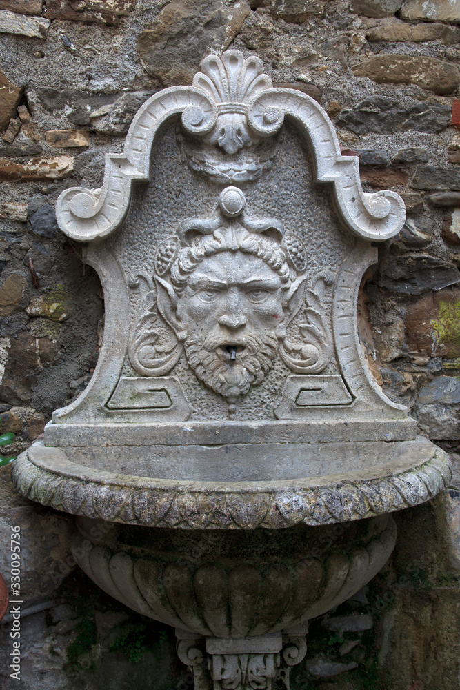 Dolceacqua (IM), Italy - December 19, 2017: An old fountain in Dolceacqua village, Imperia, Liguria, Italy