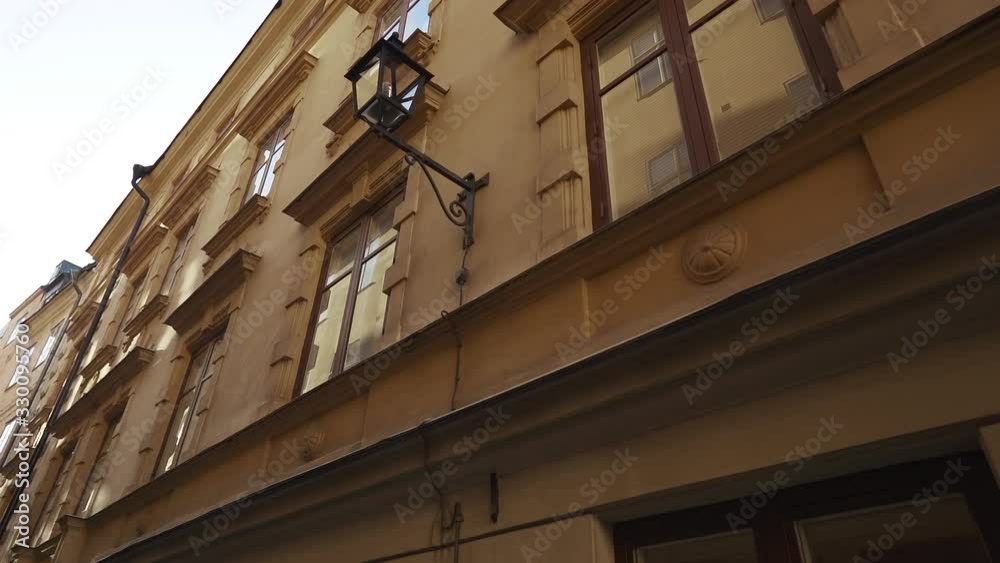Apartment buildings on european streets in old northern city. Scandinavian windows. Facades of colorful houses in narrow streets of Stockholm, Sweden. Traveling concept. Slow motion. Steadicam shot Apartment buildings on european streets in old northern city. Scandinavian windows. Facades of colorful houses in narrow streets of Stockholm, Sweden. Traveling concept. Slow motion. Steadicam shot