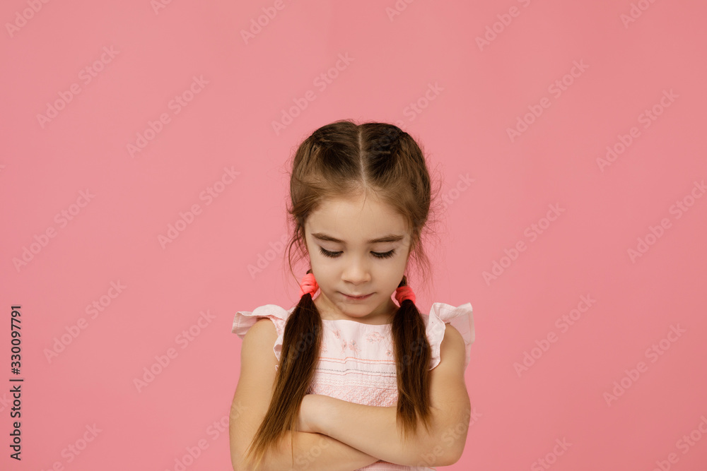 offended sad little child girl in dress on pink background. Human emotions and facial expression offended sad little child girl in dress on pink background. Human emotions and facial expression