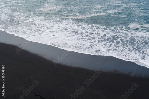 Beach with black volcanic sand near Punta Brava, Tenerife island, Spain