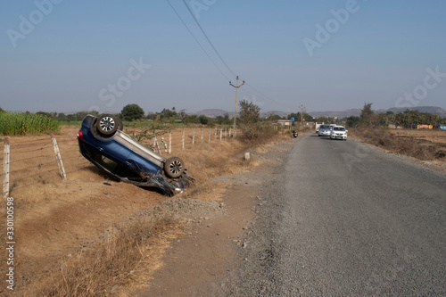 Car accident with over turned car on road