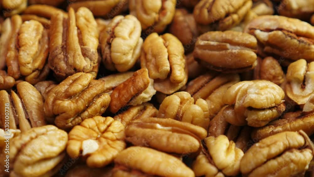 Pecan nuts background. Closeup pekan seeds. Rotate