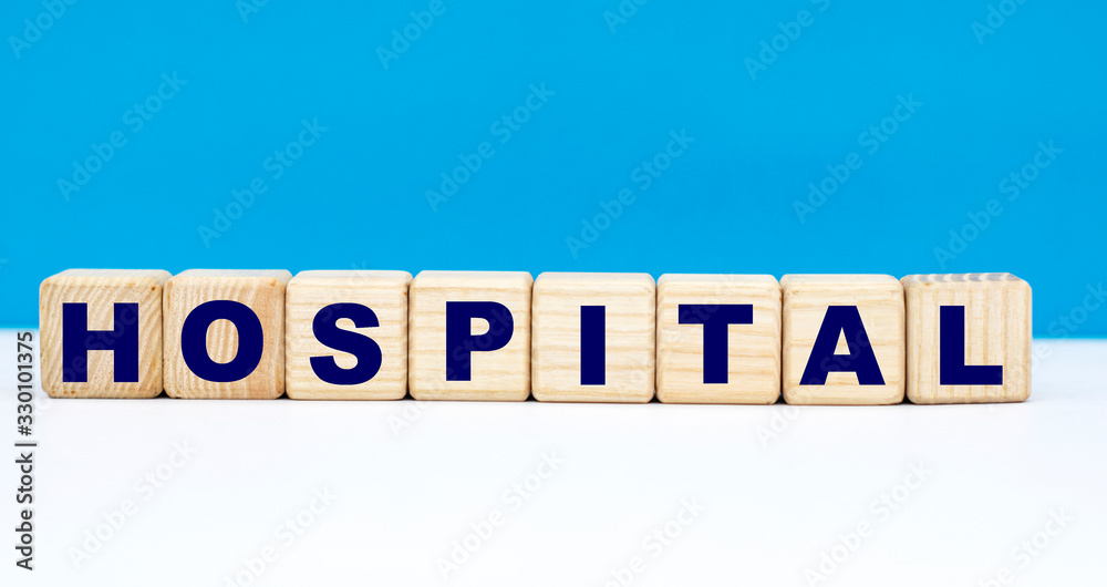 concept word hospital on cubes on a blue background