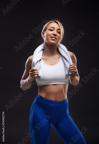 Beautiful blonde sexy girl with muscular body posing. Fitness concept. © milosducati