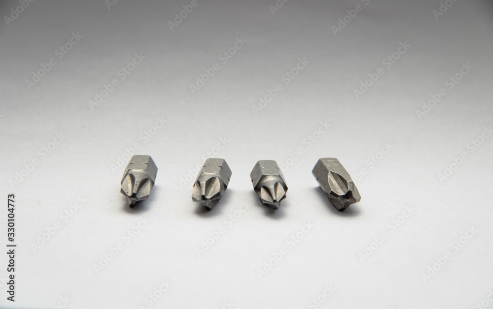 Set of bits for screwdriver. Nozzles and adapters for screwdrivers. on white background Set of bits for screwdriver. Nozzles and adapters for screwdrivers. on white background