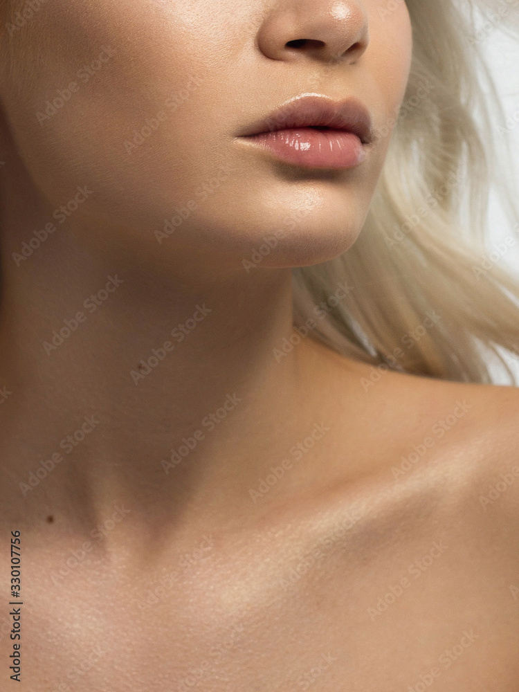 Sexual full lips. Natural gloss of lips and woman's skin. The mouth is closed. Increase in lips, cosmetology. Pink lips and long neck. Gentle pure skin and wavy blonde hair. Sexual full lips. Natural gloss of lips and woman's skin. The mouth is closed. Increase in lips, cosmetology. Pink lips and long neck. Gentle pure skin and wavy blonde hair.