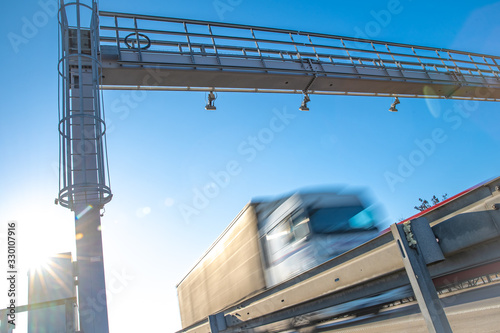 truck passing through a toll gate on a highway toll roads photo